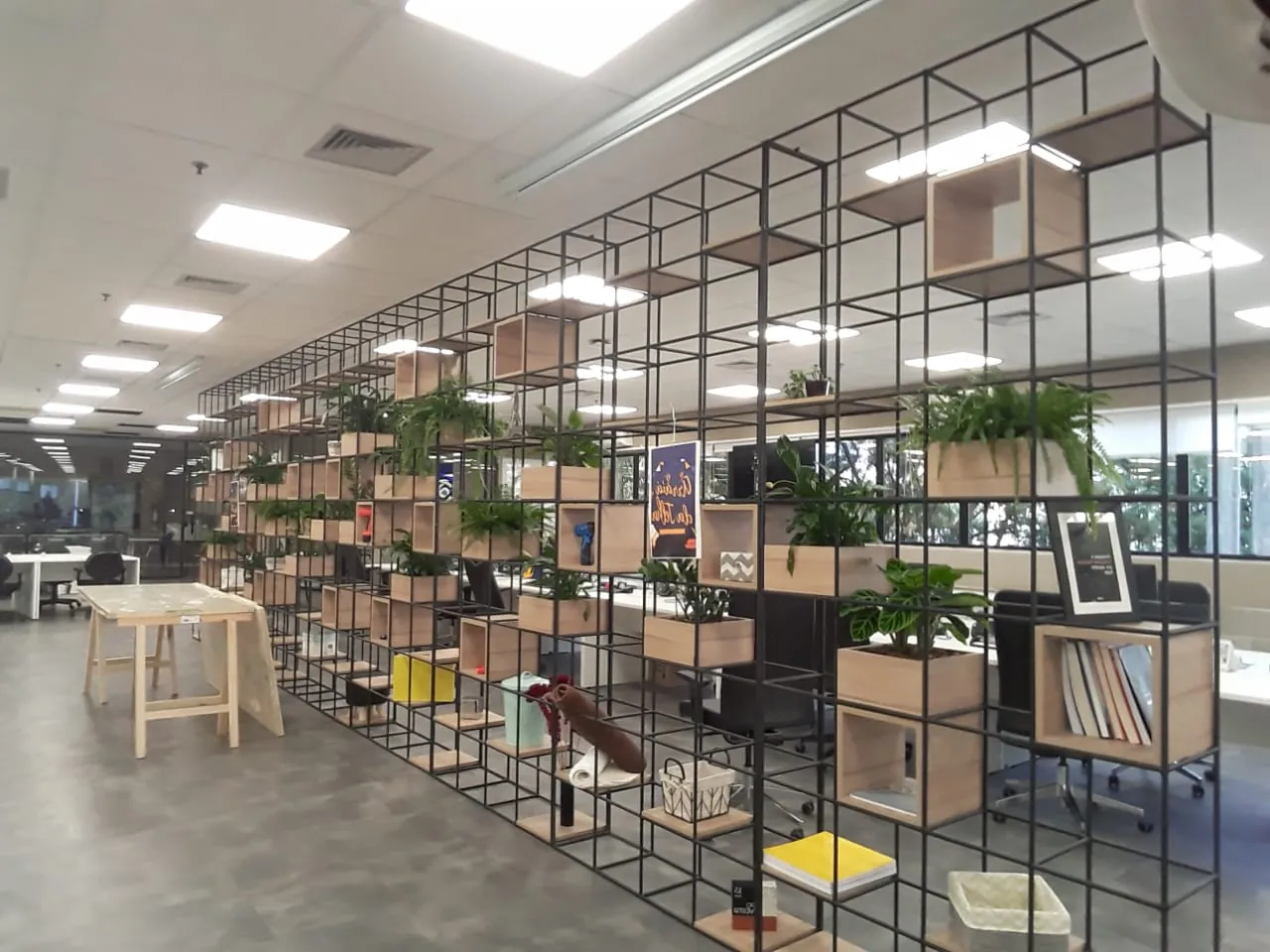 Escritório da sede Telhanorte com estante metálica de nichos e plantas